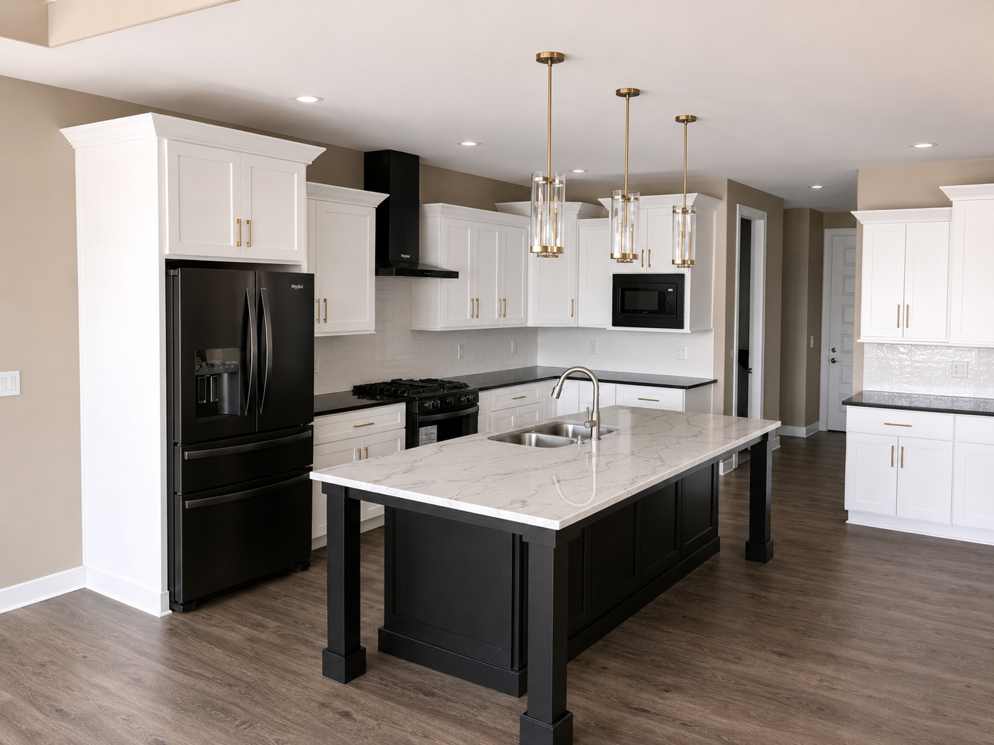 White Shaker kitchen with custom black island and gold hardware
